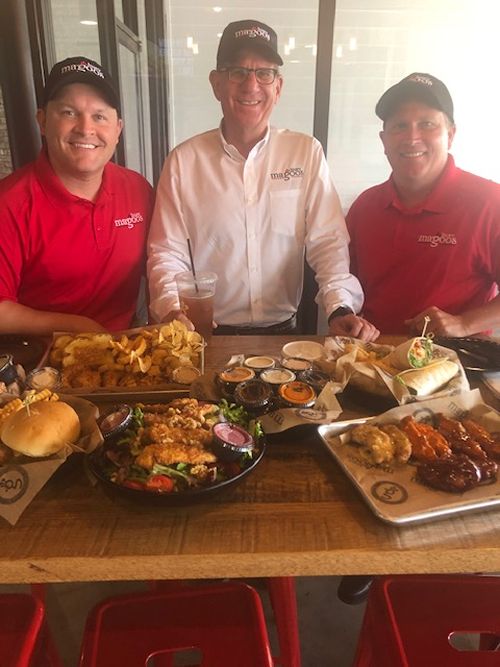 Huey Magoo’s Bryan Pagan, President and CEO Andy Howard, and James