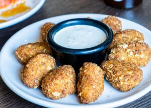 Spice Up Your Next Meal with Mike’s Hot Honey and Queso Loaded Tots at Straw Hat Pizza