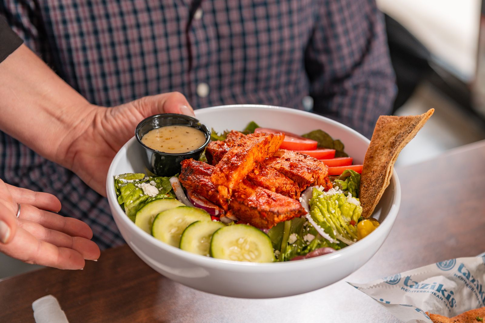 Taziki's Is Upping Its Game with New Flavors and Menu Taziki's Greek Salad with Spicy Harissa Chicken